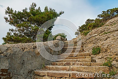 Ancient mountain stone staircase leading to the top of the mountain Stock Photo