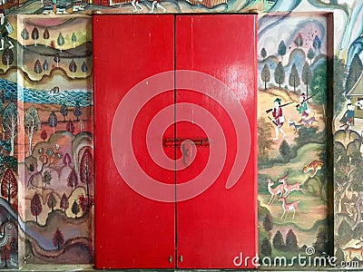 Ancient mural wall painting and red door at Thai temple Stock Photo