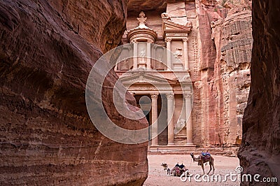 Ancient nabataean temple Al Khazneh Treasury located at Rose city - Petra, Jordan. Two camels infront of entrance. View from Siq Stock Photo