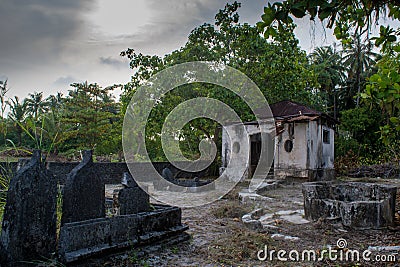 Ancient old creepy cemetery with crypt and graves at the tropical local island Fenfushi Stock Photo