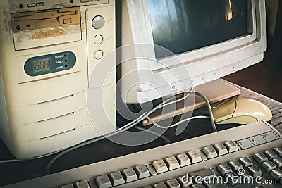 Ancient old and obsolete personal computer home use on old table wood. Obsolete technology concept. Stock Photo