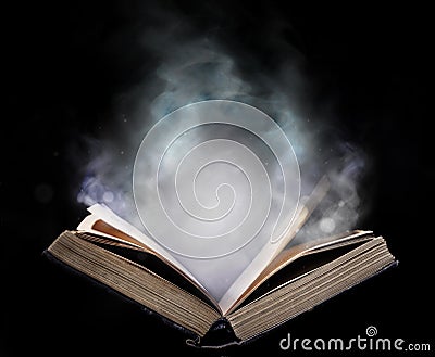 Ancient open book in the magical smoke Stock Photo