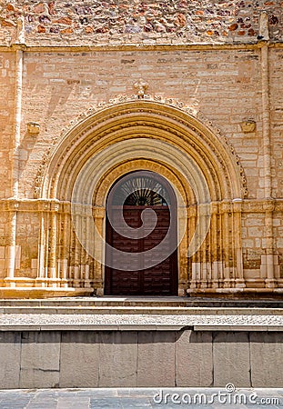 Ancient ornate wooden door of a church in Spain. Stock Photo