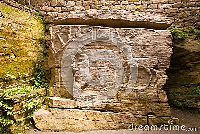 Ancient pagan cave temple with figures of tree, woman and deer carved in stone, symbols of life, maternity and clan, religion Editorial Stock Photo