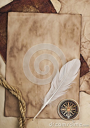 Ancient paper, feather and compass Stock Photo