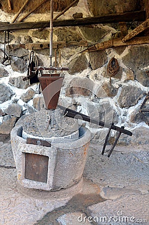 The ancient part of the oil press millstone ancient olive oil production machinery, stone mill and mechanical press is found in cl Stock Photo