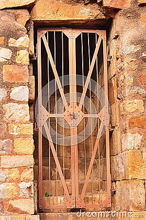 Ancient red sandstone minaret old architecture and old gate. Part of the Qutb complex Stock Photo
