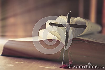 Ancient religious book and wooden cross on the background of a wooden Stock Photo