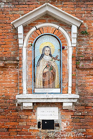 Religious mosaic on a narrow street in Venice, Italy Stock Photo