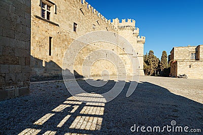 Ancient Rhodes castle with main square. look a shadow from the fence and the person standing in it Stock Photo