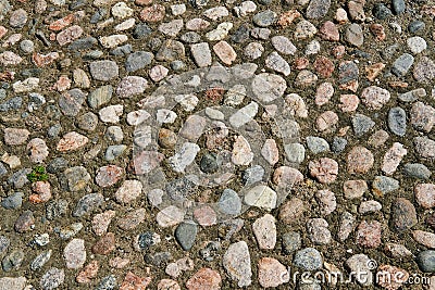 Ancient road surface paved with cobblestone, texture for design and background. Stock Photo