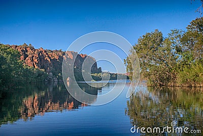 Ancient rocks reflected in calm water at Lake Argyll Stock Photo