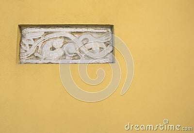 Ancient Roman Bas-relief art in a yellow wall Stock Photo