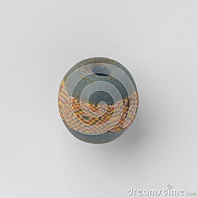 Ancient Roman glass bead with an ornamental band Stock Photo