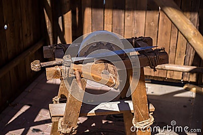 Ancient roman grindstone sharpening swords. historical recreation Stock Photo