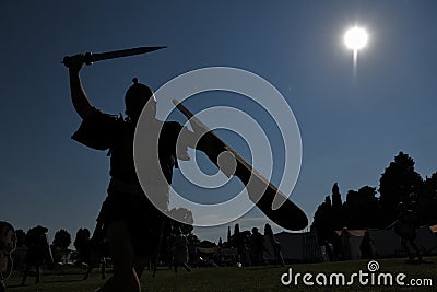 An ancient Roman legionary fights with sword, helmet and shield Editorial Stock Photo