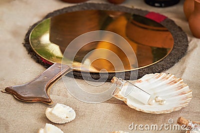 Ancient Roman mirror, retro perfume and vintage bath accessories. Reconstruction of events in the thermae of the Roman Empire Stock Photo