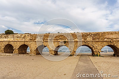 Ancient Roman ruins of aqueduct in Ceasarea Israel historical monument. Editorial Stock Photo