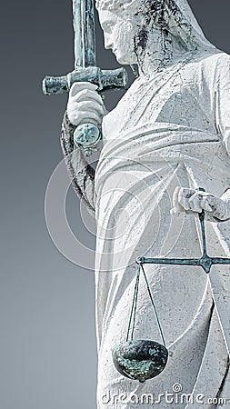 Ancient roof statue of goddess Justice with sword and scale isolated as a decoration at the top of Doge`s Palace in Venice, Italy Stock Photo