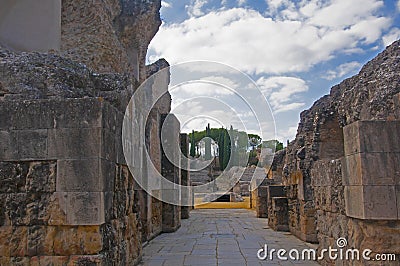 Ancient ruined walls in the way to amphitheatre .Natural park in the roman city Italica, Seville, Spain Stock Photo