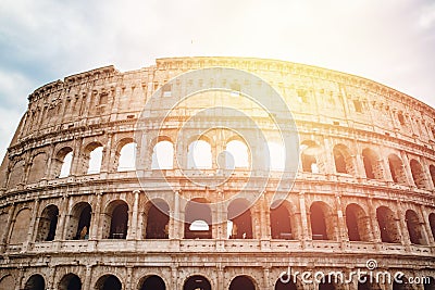 Ancient ruins Colosseum Rome, Italy, background blue sky with clouds, sunset light Stock Photo