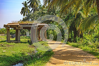 Sandy road and ancient ruins in Hampi, India Stock Photo