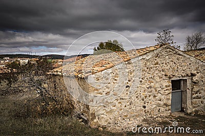 Ancient rustic country house on a cloudy day Stock Photo