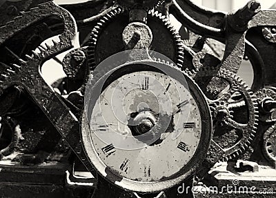 Ancient rusty broken iron clock with weathered face and exposed complex mechanism of cogs and gears Stock Photo
