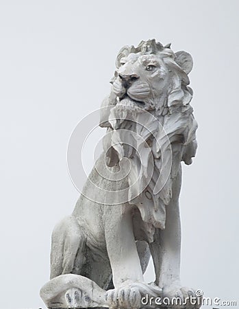 Ancient Sculpture of White sitting Coade stone Lion isolated on white backgrounds, clad strong statue, leadership symbol monument Stock Photo