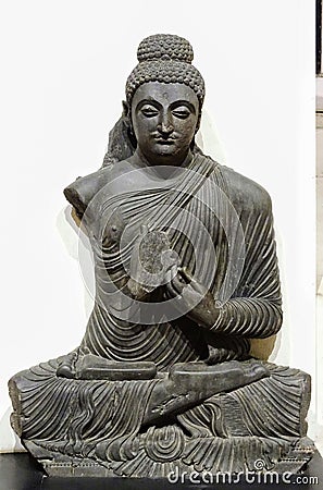 An ancient sitting Buddha& x27;s idol kept in a museum Editorial Stock Photo