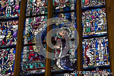 Ancient stained glass windows on a religious theme in the Cathedral of the Blessed Virgin Mary in Munich Germany. Editorial Stock Photo