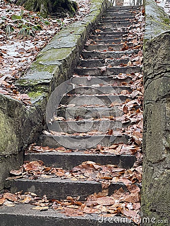 dilapidated antique staircase in the park, keeping many secrets Stock Photo