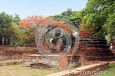 Ancient statue of Buddha in ruins, inside an old temple. Ayutthaya, Thailand Stock Photo
