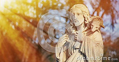 Ancient statue of Jesus Christ Good Shepherd with the lost sheep on his shoulders. Biblical tradition, religion, Christianity, God Stock Photo