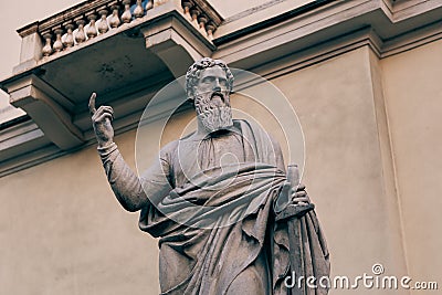 Ancient statue points with index finger at the sky Stock Photo