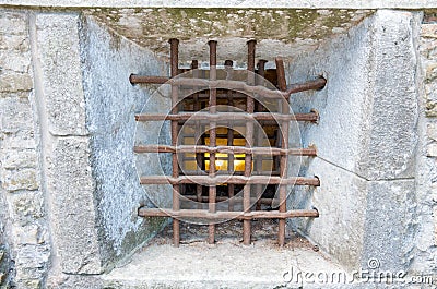 Prison wall with metal window bars Stock Photo