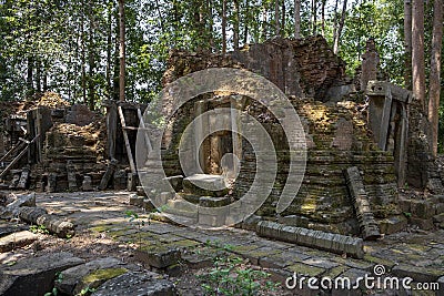 Ancient stone ruin of Preah Monti temple, Roluos, Cambodia. Stone carved decor on hindu temple. Cambodian landscape Stock Photo