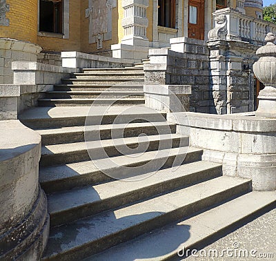 Ancient stone staircase in three marches with wide concrete steps Stock Photo