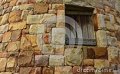 An ancient stone structure with a wooden hatch Stock Photo