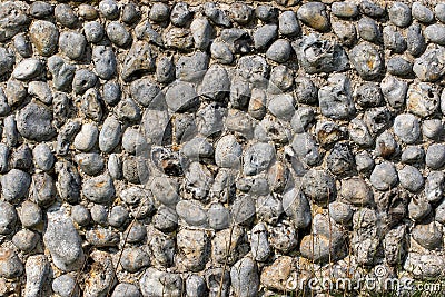Ancient stone wall background image. Old English pebble dashed wall Stock Photo