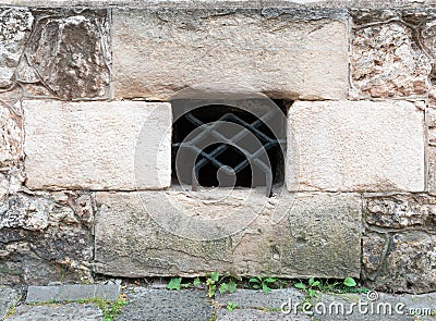 Ancient stone wall made of large limestone blocks with a dormer Stock Photo