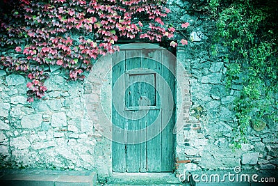 Ancient stone wall and a wooden closed door Stock Photo