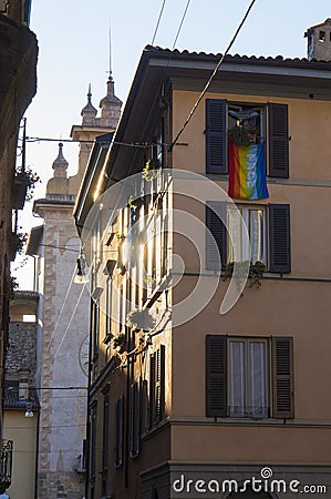 An ancient street of Old Town Citta Alta of Bergamo with rainbow flag on the balcony. Italy Stock Photo