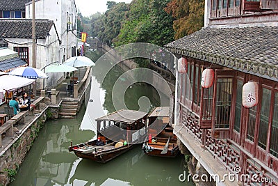 Ancient tea house and boats in a canal in the ancient water town Suzhou, China Editorial Stock Photo