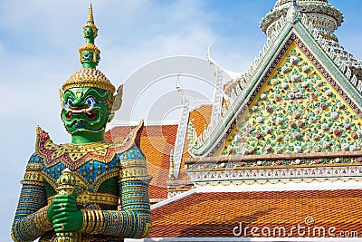 Ancient temple guardian in front of Temple of Dawn Wat Arun Buddhist Temple is green demon giant statue. Editorial Stock Photo