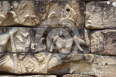 Ancient temple stone carved bas-relief in Angkor Wat. Smiling woman dancing apsara closeup. Stock Photo