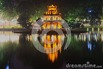 Ancient Temple of Turtles on the background of the waterfront Hoan Kiem lake in the night illumination. Hanoi Stock Photo