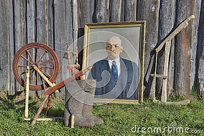 Ancient things near barn, painting Lenin, spinning wheel, felt boots Editorial Stock Photo