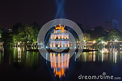 An ancient tower of the Turtle in beams of searchlights on the lake Hoankyem. Hanoi, Vietnam Stock Photo