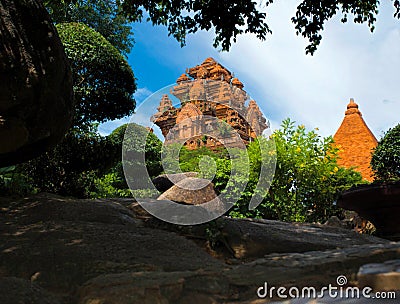 The ancient towers of Ponagar are seen from the dense vegetation of the park. Stock Photo